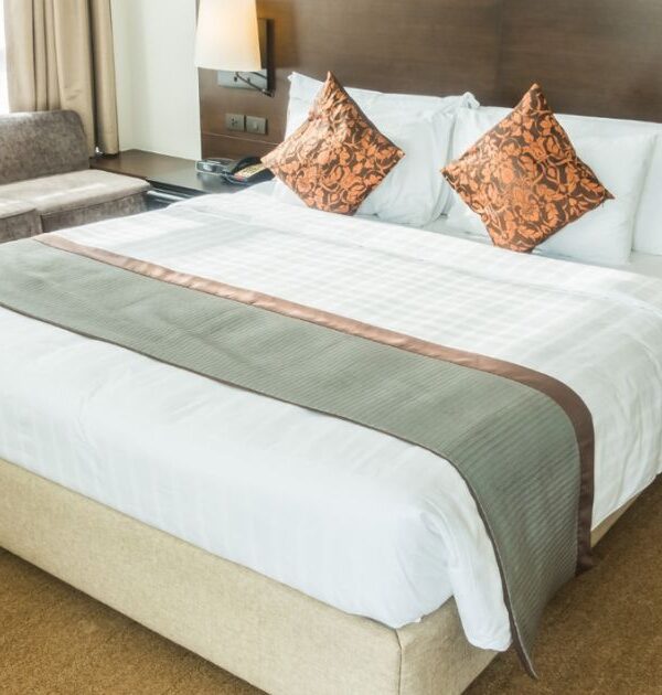 Modern bedroom setup with luxury bed from a top furniture store Ahmedabad, also featuring stylish sofas from leading home furnishing stores and premium mattresses shop collection.
